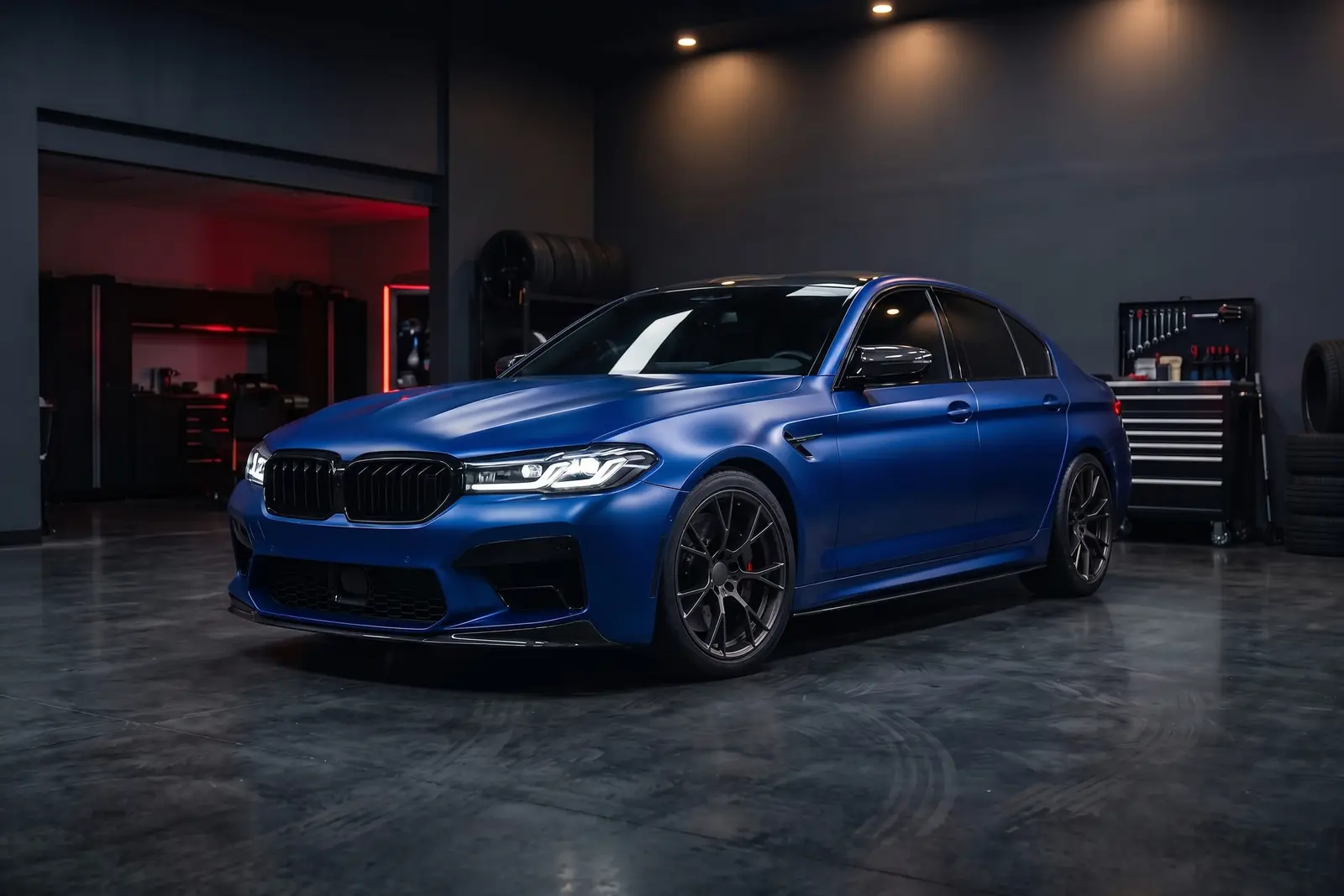 Satin blue full color change wrap on a performance sedan in a professional studio